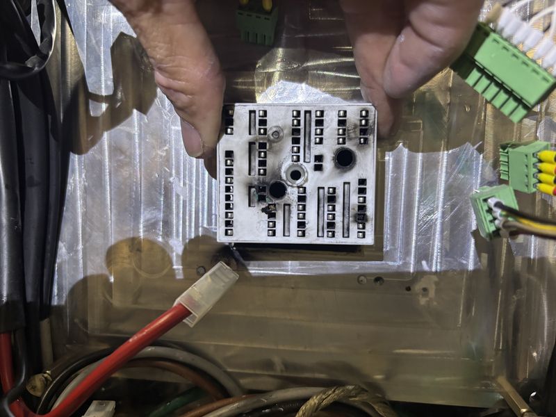 Unit 3 inverter: power module on its heatsink, scorch marks visible, connectors unplugged.