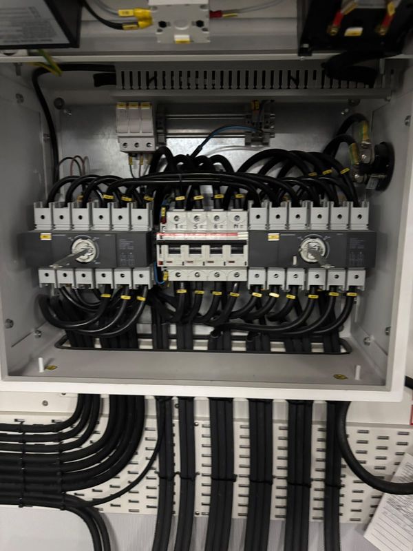 Shore-power changeover cabinet: two 4-pole changeover switches and a 4-pole breaker.