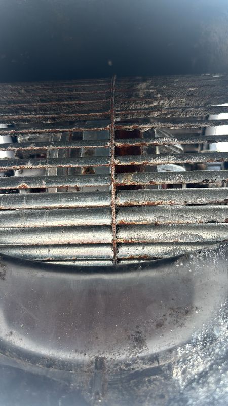 Cabin fan-coil blower grille, close-up of rust.