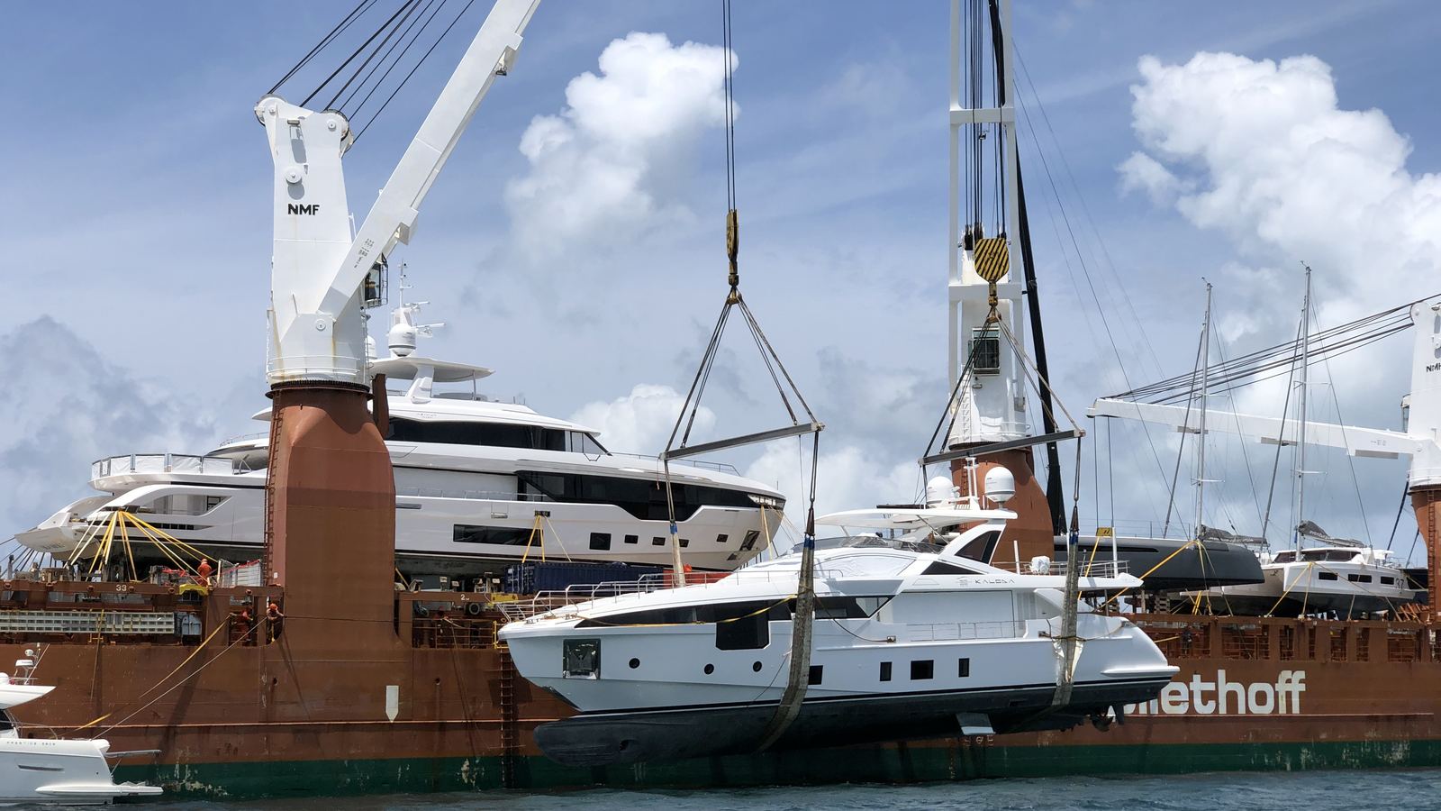 M/Y Kaloda, a 32 m Azimut Grande, being lifted by crane from a heavy-lift transport ship on delivery